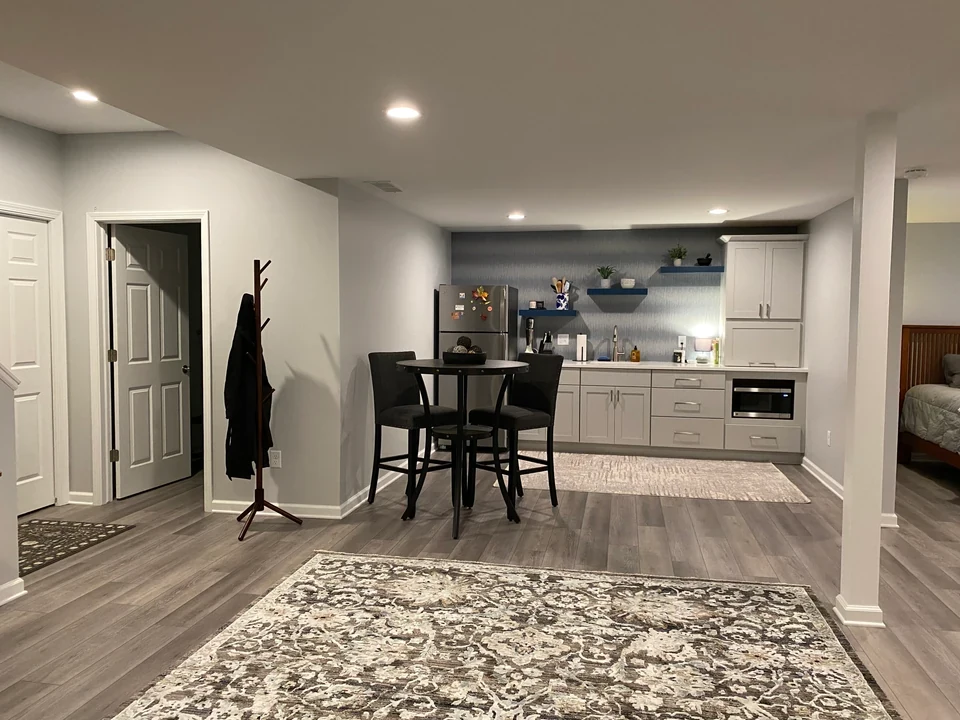 Finished lower-level living area with a connected dining space.